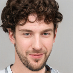 Joyful white young-adult male with short  brown hair and blue eyes