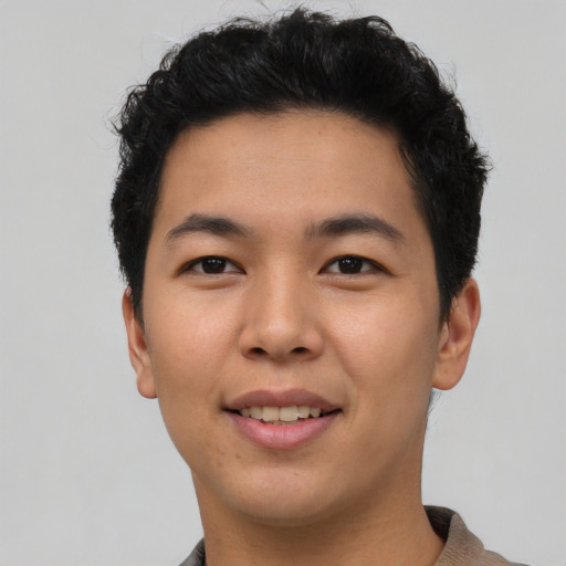 Joyful asian young-adult male with short  black hair and brown eyes
