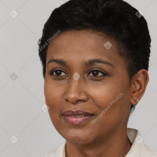 Joyful black young-adult female with short  black hair and brown eyes