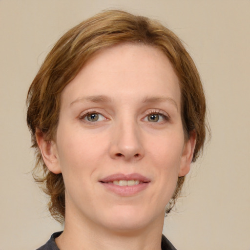 Joyful white young-adult female with medium  brown hair and green eyes