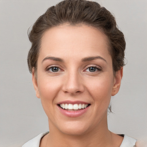 Joyful white young-adult female with short  brown hair and brown eyes