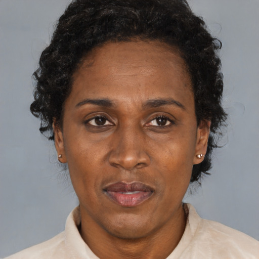 Joyful black adult female with short  brown hair and brown eyes