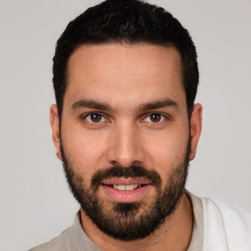 Joyful white young-adult male with short  black hair and brown eyes