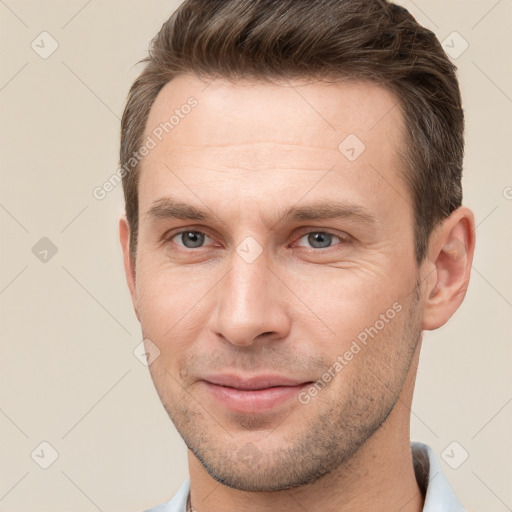 Joyful white young-adult male with short  brown hair and brown eyes