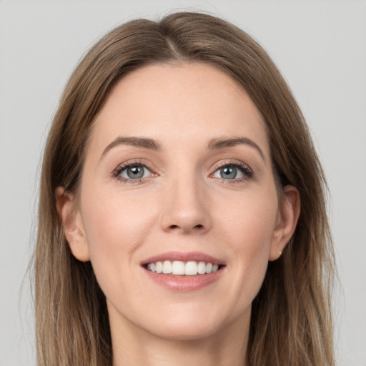 Joyful white young-adult female with long  brown hair and grey eyes