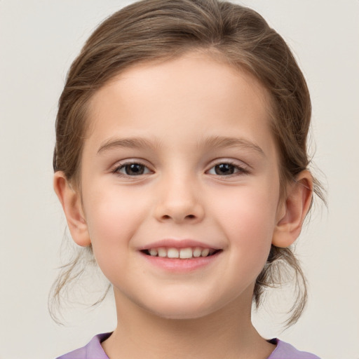 Joyful white child female with medium  brown hair and brown eyes