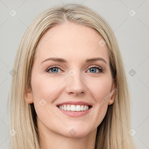 Joyful white young-adult female with long  brown hair and blue eyes