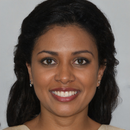 Joyful black young-adult female with medium  brown hair and brown eyes