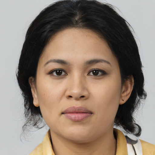 Joyful asian young-adult female with medium  black hair and brown eyes