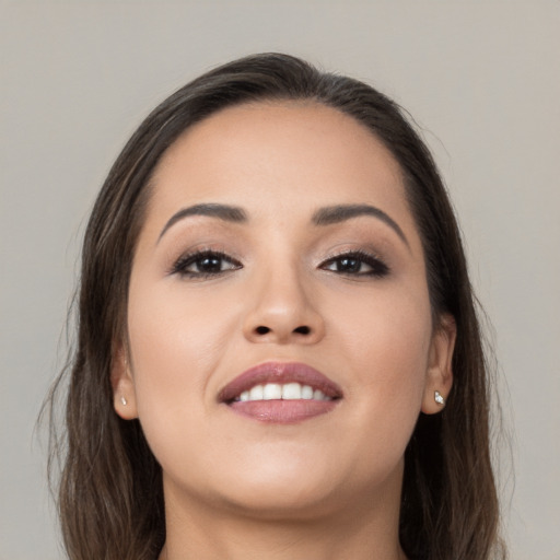 Joyful white young-adult female with long  brown hair and brown eyes