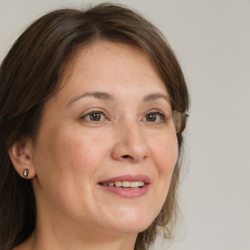 Joyful white adult female with medium  brown hair and grey eyes