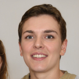 Joyful white young-adult female with short  brown hair and grey eyes