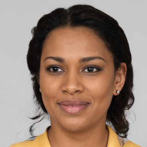 Joyful black young-adult female with medium  black hair and brown eyes