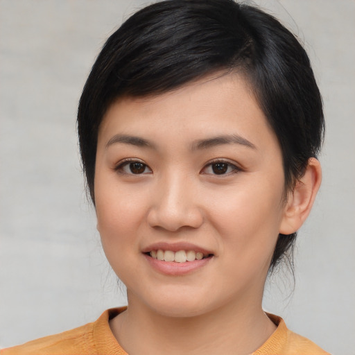 Joyful asian young-adult female with medium  black hair and brown eyes