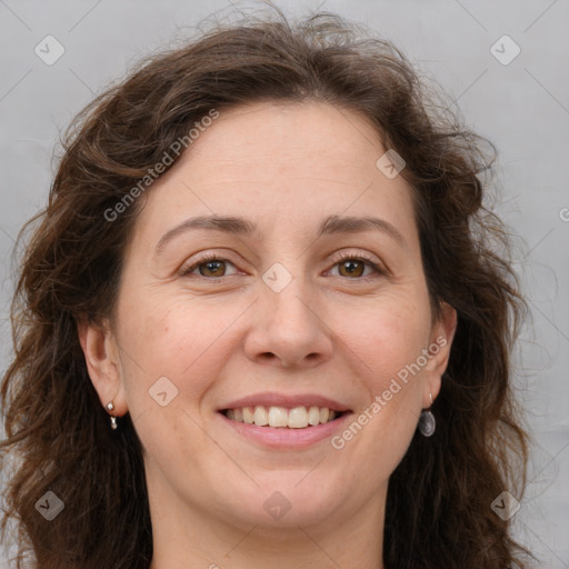 Joyful white adult female with long  brown hair and grey eyes