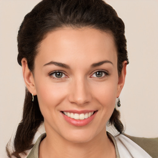 Joyful white young-adult female with medium  brown hair and brown eyes