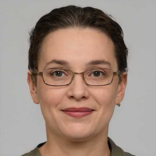 Joyful white adult female with short  brown hair and grey eyes