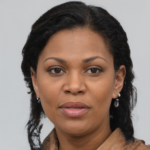 Joyful black young-adult female with long  brown hair and brown eyes