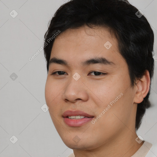 Joyful asian young-adult male with short  black hair and brown eyes