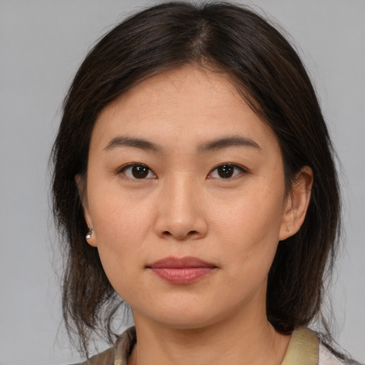 Joyful asian young-adult female with medium  brown hair and brown eyes