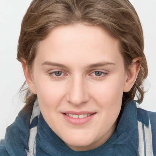 Joyful white young-adult female with medium  brown hair and blue eyes