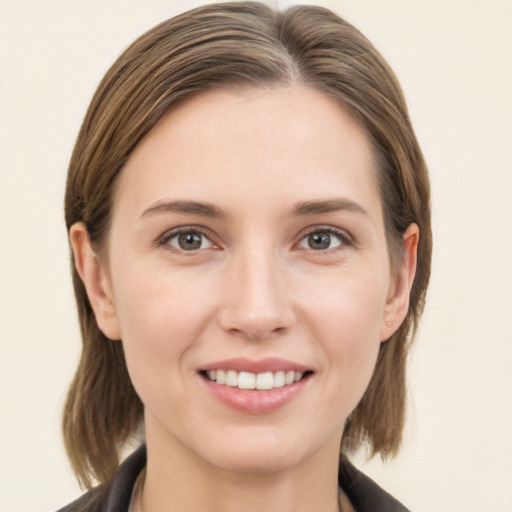 Joyful white young-adult female with medium  brown hair and grey eyes