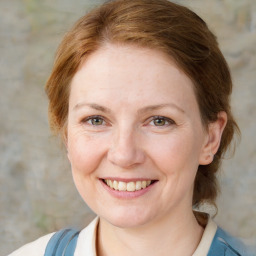 Joyful white adult female with medium  brown hair and blue eyes