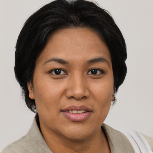 Joyful asian adult female with short  brown hair and brown eyes