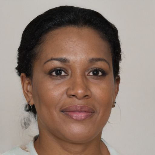 Joyful black adult female with short  brown hair and brown eyes