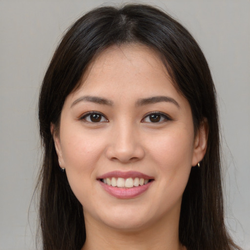 Joyful white young-adult female with long  brown hair and brown eyes