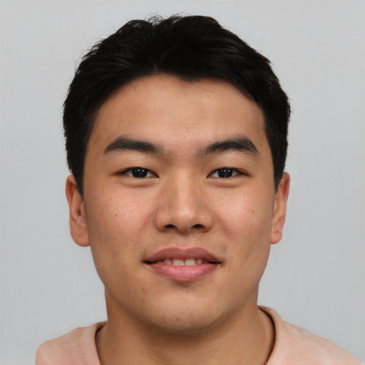 Joyful asian young-adult male with short  black hair and brown eyes