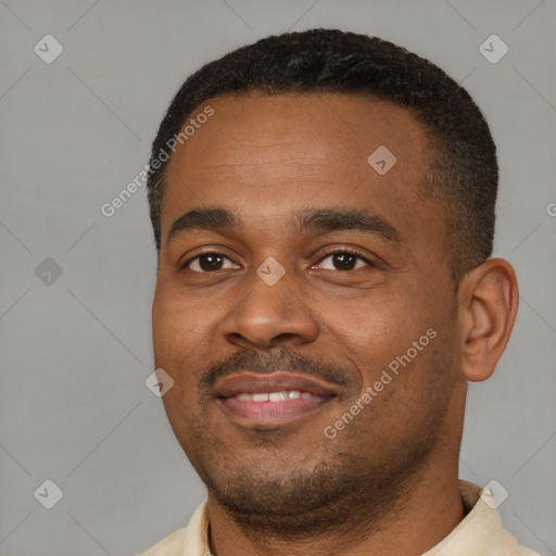 Joyful black young-adult male with short  black hair and brown eyes