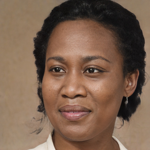 Joyful black adult female with medium  brown hair and brown eyes