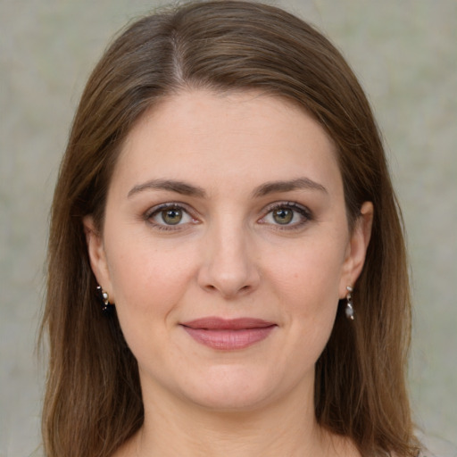 Joyful white young-adult female with medium  brown hair and green eyes