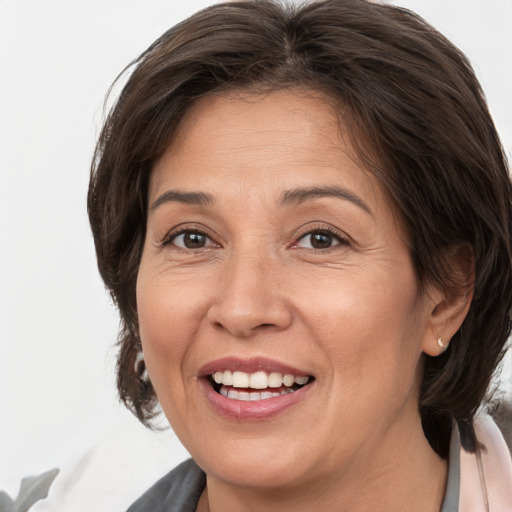 Joyful white adult female with medium  brown hair and brown eyes