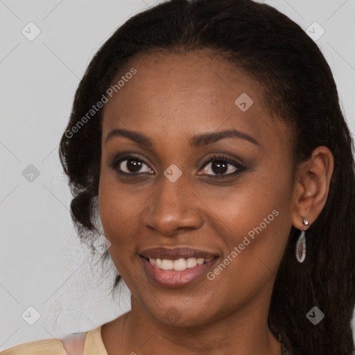 Joyful black young-adult female with long  brown hair and brown eyes