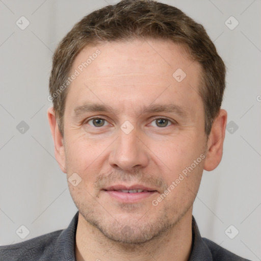 Joyful white adult male with short  brown hair and grey eyes