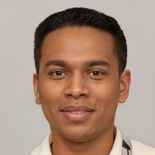 Joyful black young-adult male with short  black hair and brown eyes