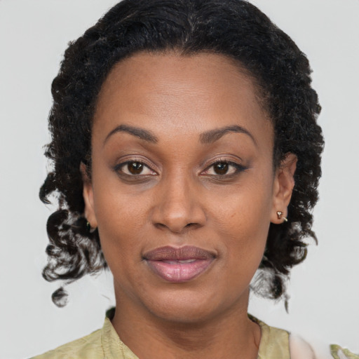 Joyful black young-adult female with medium  brown hair and brown eyes
