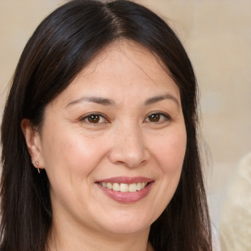 Joyful white adult female with long  brown hair and brown eyes