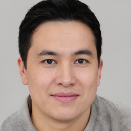 Joyful asian young-adult male with short  brown hair and brown eyes