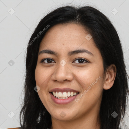 Joyful latino young-adult female with long  brown hair and brown eyes