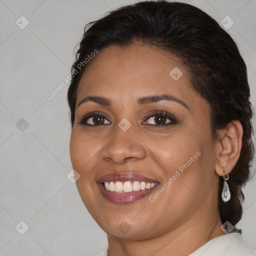 Joyful latino young-adult female with medium  brown hair and brown eyes