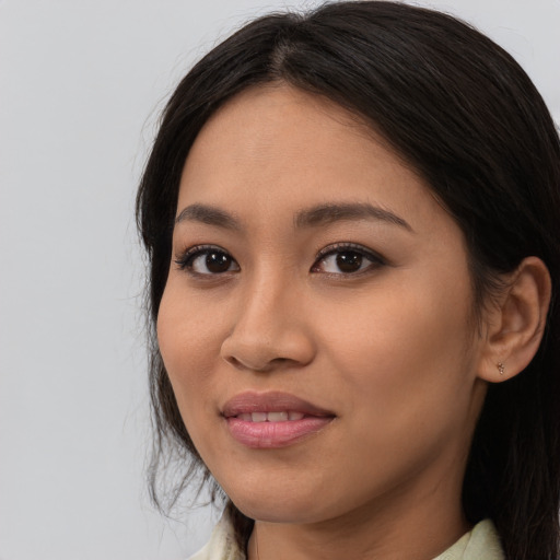 Joyful asian young-adult female with long  brown hair and brown eyes