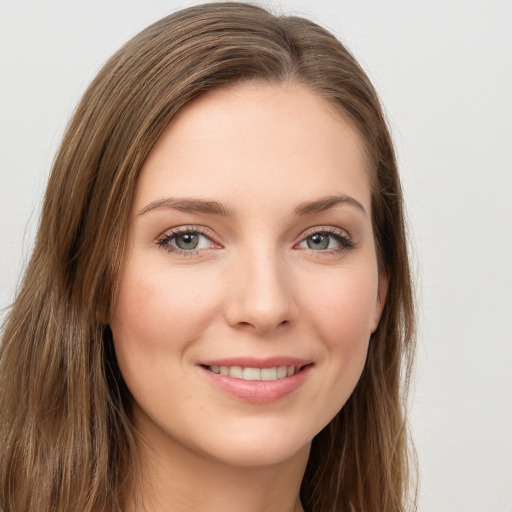 Joyful white young-adult female with long  brown hair and green eyes