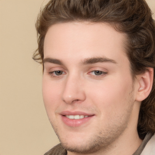 Joyful white young-adult male with medium  brown hair and brown eyes