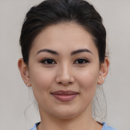 Joyful asian young-adult female with medium  brown hair and brown eyes