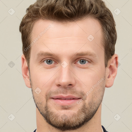 Joyful white young-adult male with short  brown hair and grey eyes