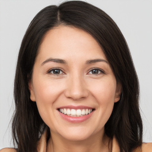 Joyful white young-adult female with long  brown hair and brown eyes