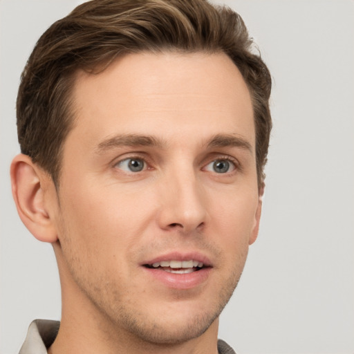 Joyful white young-adult male with short  brown hair and grey eyes